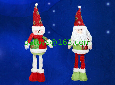 La muñeca y el muñeco de nieve grandes de Papá Noel con el día de fiesta de la Navidad de la pierna de Streaching para celebran el partido